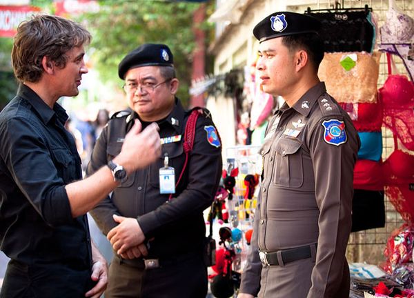 Men in police uniforms outdoors, occupationally.