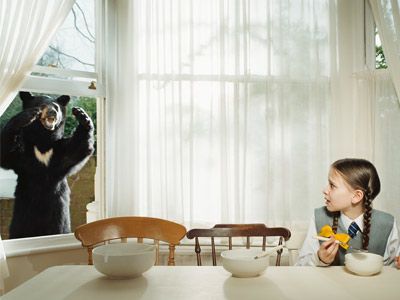 Girl scared by bear at window