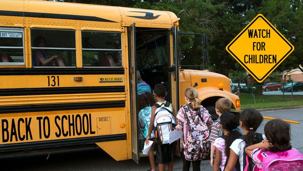 kids getting on school bus