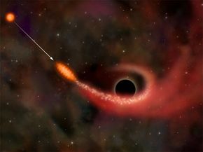 A supermassive black hole ripping apart a star and consuming a portion of it.