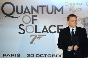 Actor Daniel Craig poses in front of a poster for the James Bond film 'Quantum of Solace.' The title means a really small amount of comfort.