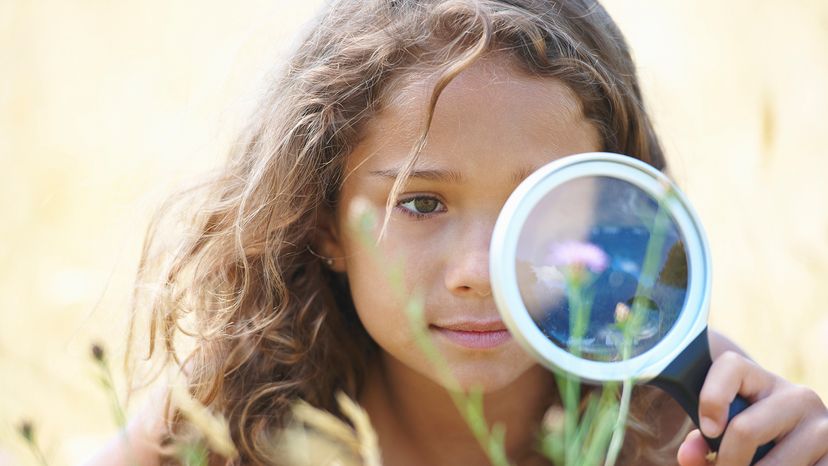 Girl with magnifying glass