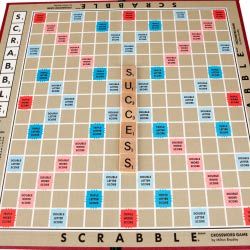 A Scrabble board with a single word, "success," played on it.