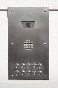 The type of security camera system a person installs, like this tiny camera inside an intercom, depends on the kind of activity under surveillance.