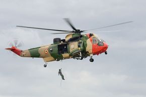 Rescue helicopter flying with military propeller.