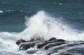 Ocean waves crash against rocks.