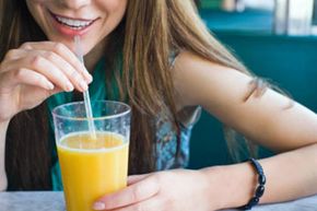 woman drinking orange juice