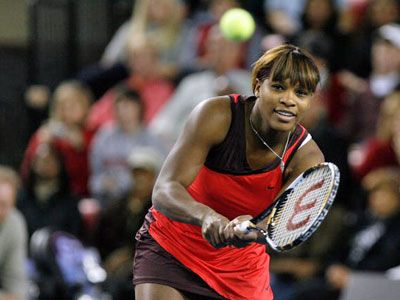 Serena Williams returns a shot during the doubles match at the Rock n' Racquets exhibition at Stegeman Coliseum.