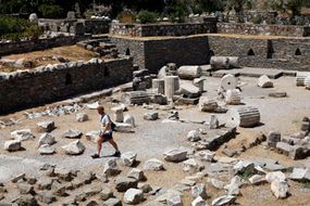 A tourist walks through the ruins of the Mausoleum of Halicarnassus in Bodrum, Turkey.