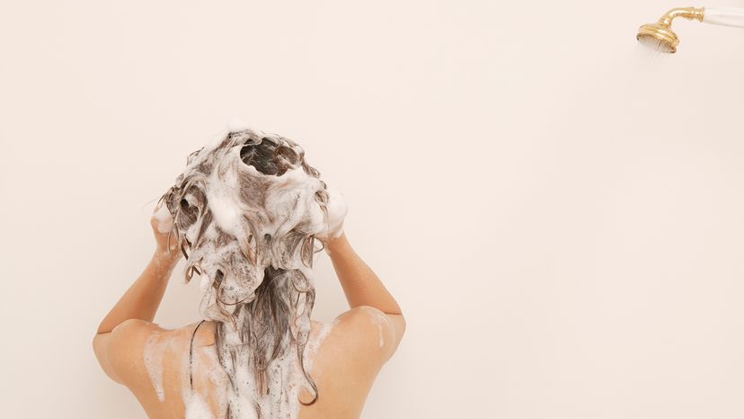 Woman washing hair in shower