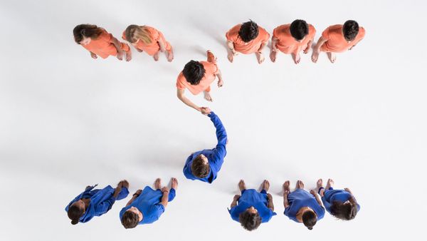 Team of blue-clad men, isolated on white background.