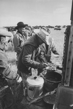 Cowboys on a cattle drive from South Dakota to Nebraska are fed from the chuckwagon.