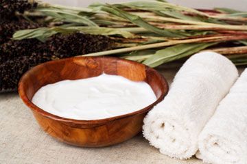 Beauty treatment. Shea butter (skin cream made from african shea nuts) in bamboo wooden bowl