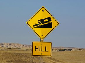 A road sign warns of a steep downhill section ahead. See more truck pictures.