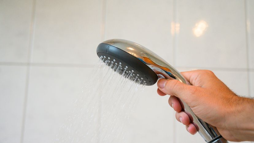 Leaks can occur where the head connects to the shower arm or between the showerhead body and the swivel ball Aitor Diago / Getty Images