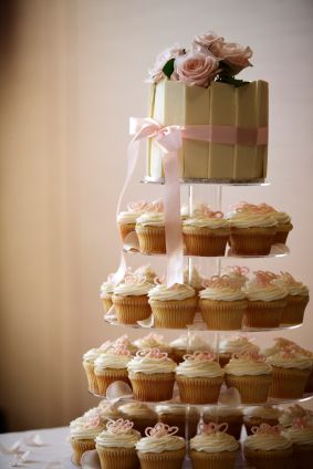 wedding cupcakes arranged on tiered platform