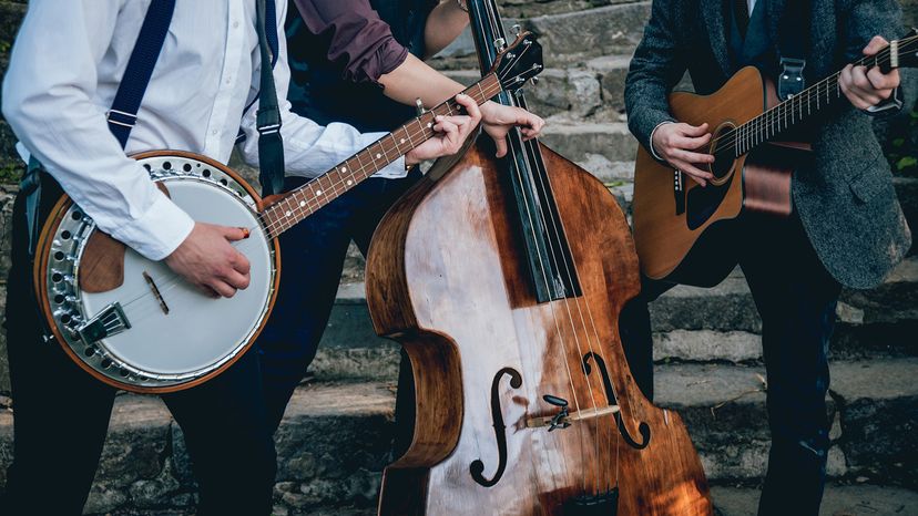 Trio of musicians with a guitar, banjo and contrabass