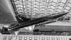 Black and white photo of a hypersonic jet hanging from the ceiling of a museum