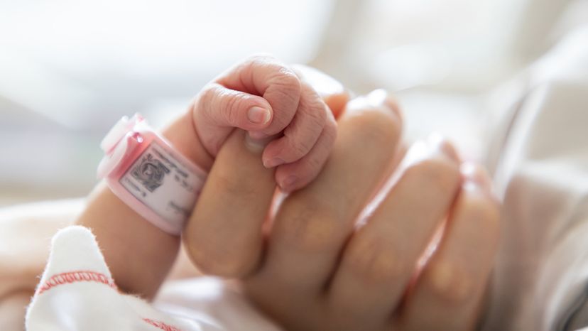 Baby holding mom's hand