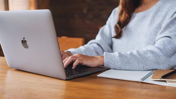 A woman using and working on Apple MacBook Pro laptop computer