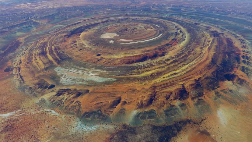 Aerial view of red, rocky mountains in concentric circles