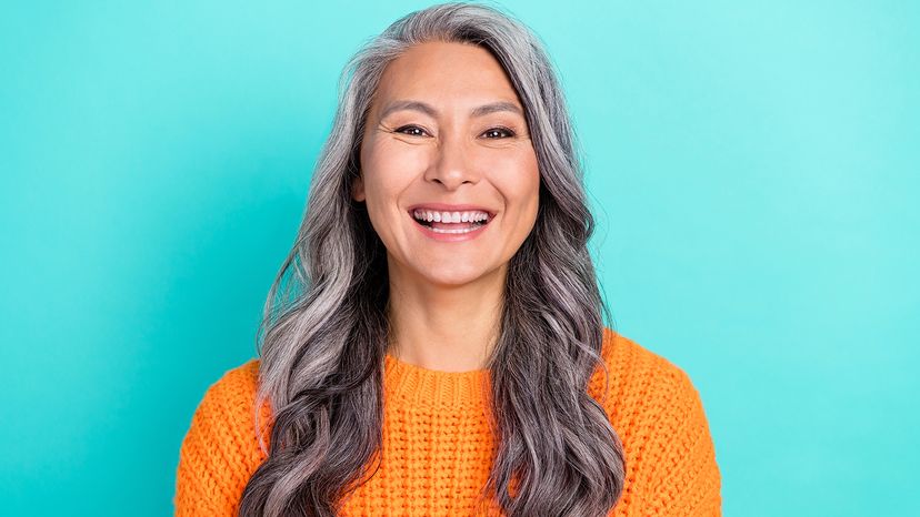 woman with long hair wearing an orange sweater