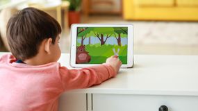 Little boy watching cartoons on tablet