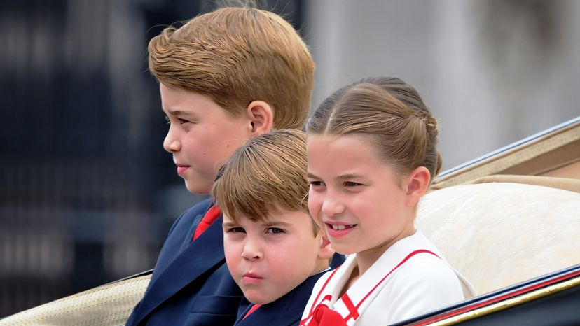 children of the british royal family ride in a carriage