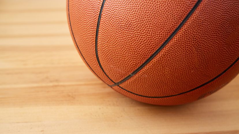 A basketball ball close-up on a wooden floor