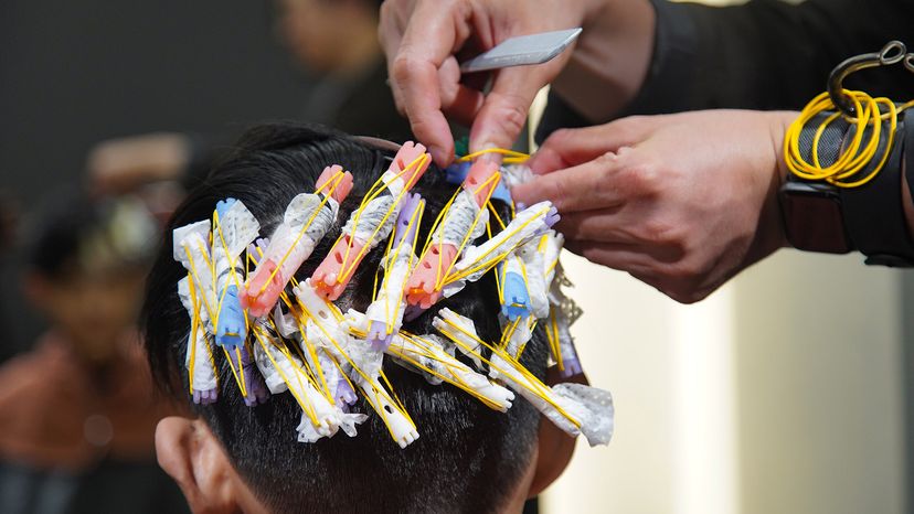 Image of a hairdresser wrapping a perm rod