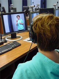 A student learning sign language through video