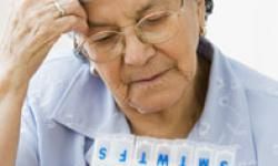 woman looking at pill organizer