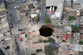 Aerial view of the huge hole in Guatemala City after the sewage system collapsed. If you look at the surrounding buildings, you can see how big that scary sinkhole is.
