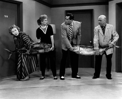 Vivian Vance, Lucille Ball, Desi Arnaz and William Frawley hold a tuna fishing contest on an episode of the sitcom I Love Lucy from 1956. 