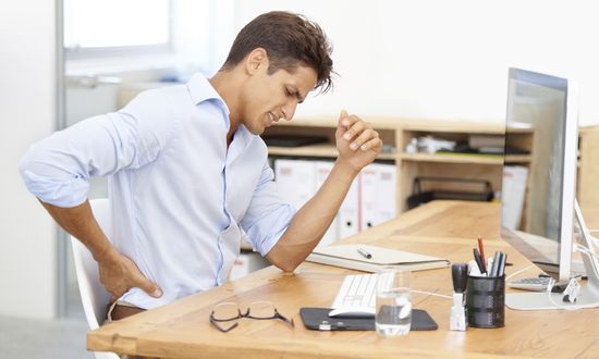 Why is sitting in a chair for long periods bad for your back?
