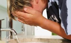 Boy washing face.