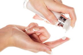 Woman hands with cream isolated on white