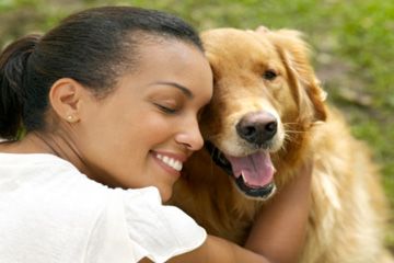 Woman hugging dog. 