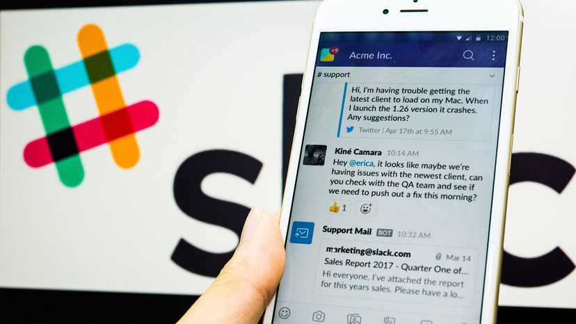 Young man uses Slack on his iPhone