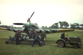 1940: Ground staff prepares to load a Hawker Typhoon with bombs.