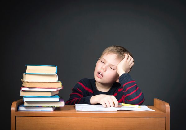 A kid sleeping after studying.
