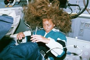 Astronaut Marsha Ivins sleeping aboard the shuttle Atlantis.