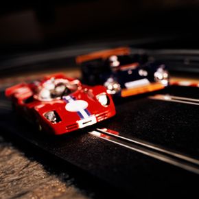 Two slot cars race for the finish line