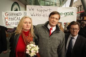 Surrounded by supporters, Dr. Andrew Wakefield (C) walks with his wife Carmel after speaking to reporters at the British General Medical Council in Jan. 2010. His medical license was revoked by that body later in the year.