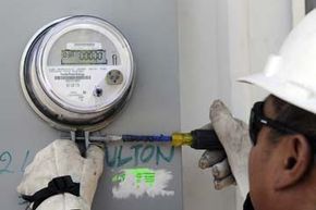 A Houston, Texas utility worker installs a smart meter for CenterPoint Energy on June 5, 2009. The utility company, which serves 2.2 million customers in the metropolitan area, expects to spend $1 billion on smart grid technology.
