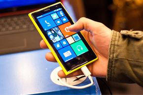 A man checks out the new Nokia Lumia 1020, which runs Windows Phone 8 and boasts a 41- megapixel camera, during London's Apps World exhibition in October 2013. 