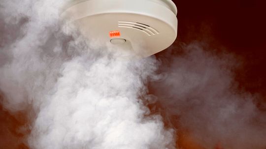 How do smoke detectors intercommunicate?