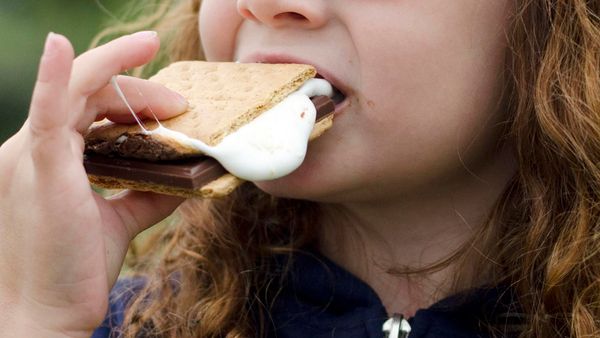 Child eating chocolate, alone.