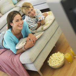 kids eating popcorn in front of TV