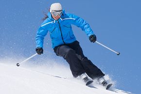 Person skiing in winter snow sport.